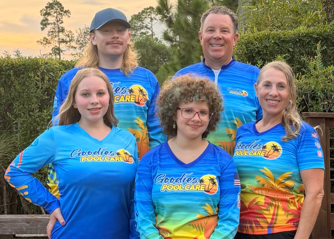 The Goodies Pool Care family, all five in their matching Goodies Pool Care shirts, standing together outside at sunset