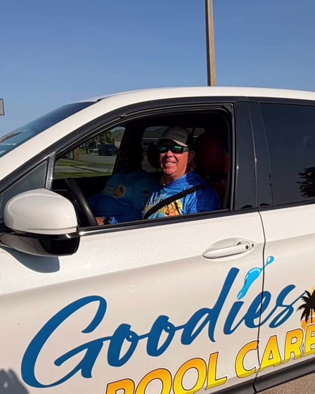A Goodies Pool Care technician at the wheel of the company truck