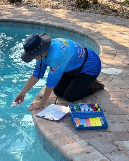 A water test kit open on the pool coping