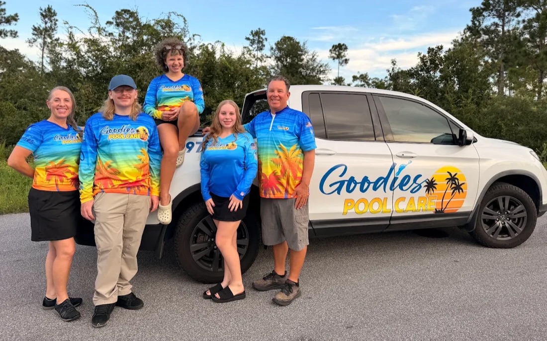 The Goodies Pool Care family in their matching Goodies shirts, standing in front of the white company truck with the Goodies Pool Care logo on the door